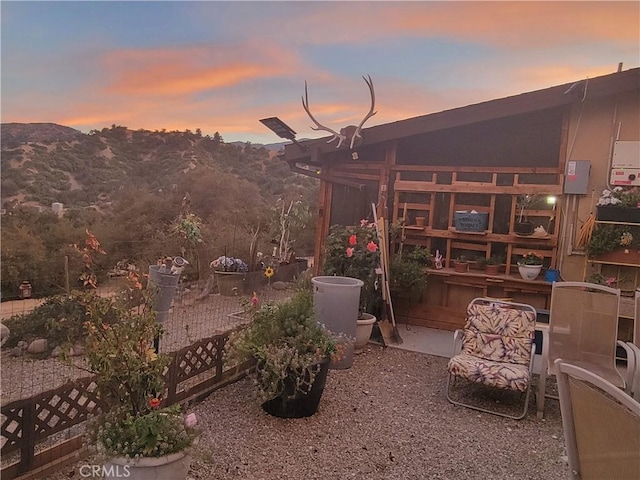 yard at dusk featuring a mountain view