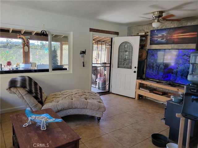 tiled living room featuring plenty of natural light and ceiling fan