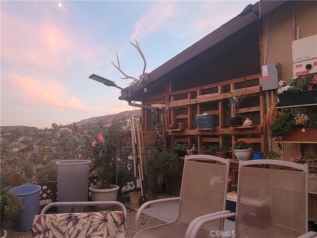 patio terrace at dusk featuring a mountain view