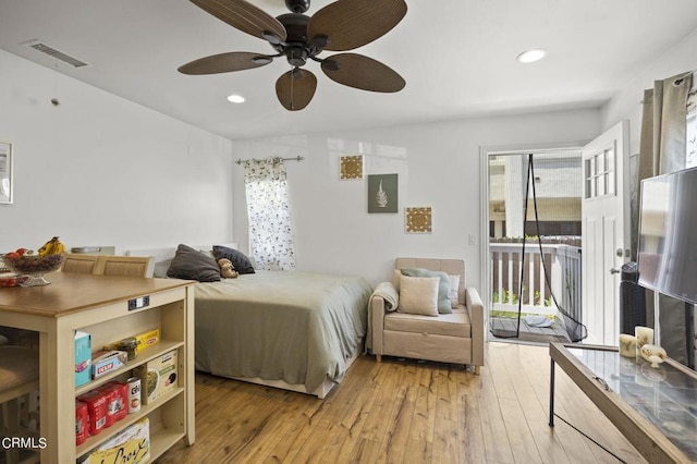 bedroom featuring access to exterior, ceiling fan, light hardwood / wood-style floors, and multiple windows