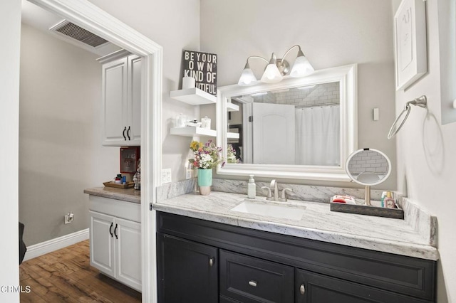 bathroom featuring vanity, curtained shower, and wood-type flooring