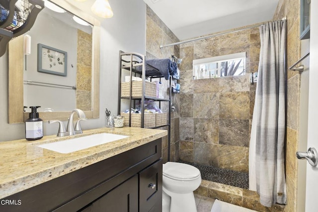 bathroom with vanity, curtained shower, and toilet