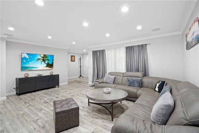 living room with light hardwood / wood-style floors and crown molding