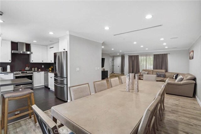 dining room featuring dark hardwood / wood-style flooring and ornamental molding