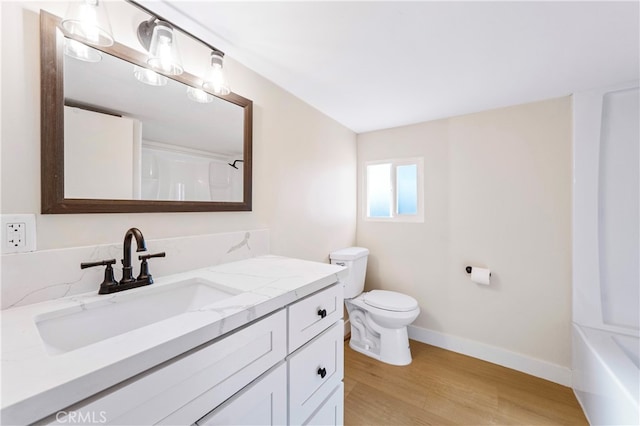 full bathroom featuring shower / bath combination, hardwood / wood-style flooring, vanity, and toilet