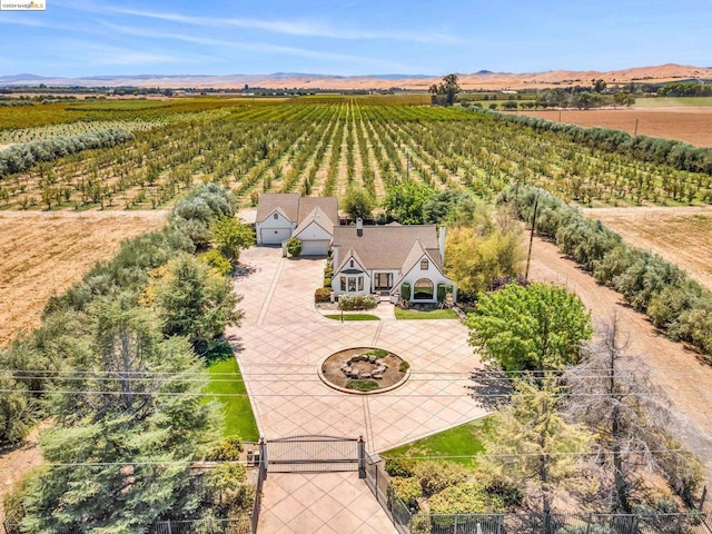 birds eye view of property featuring a mountain view and a rural view