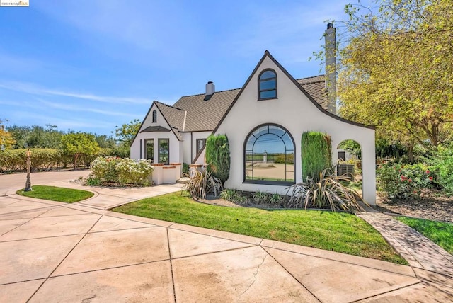 tudor house with a front yard