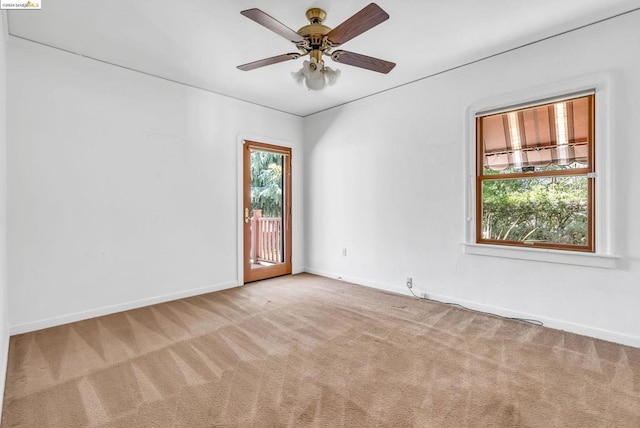 carpeted spare room with ceiling fan