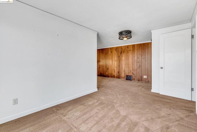 interior space featuring light carpet and wooden walls