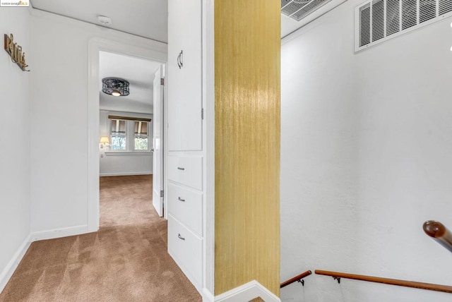 hallway with light colored carpet