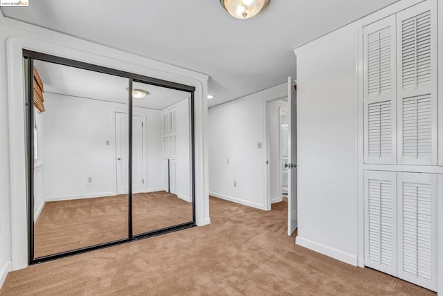 unfurnished bedroom featuring light colored carpet