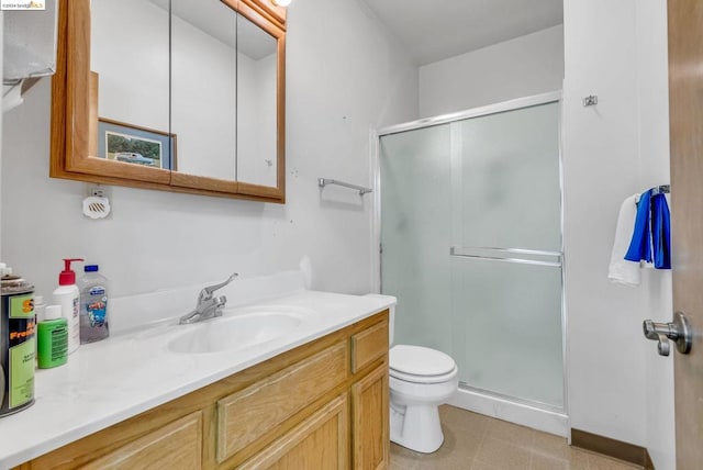 bathroom featuring a shower with door, toilet, and vanity