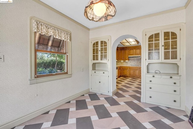 unfurnished dining area featuring crown molding