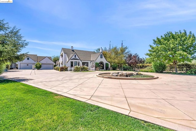 view of front of property with a front yard and a garage