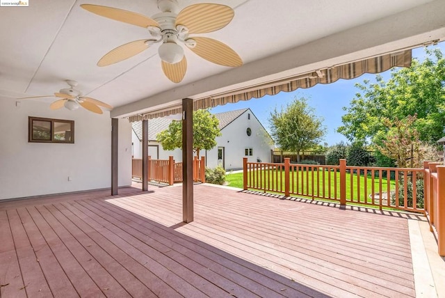 deck with a yard and ceiling fan