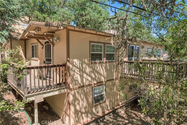 rear view of house featuring a deck