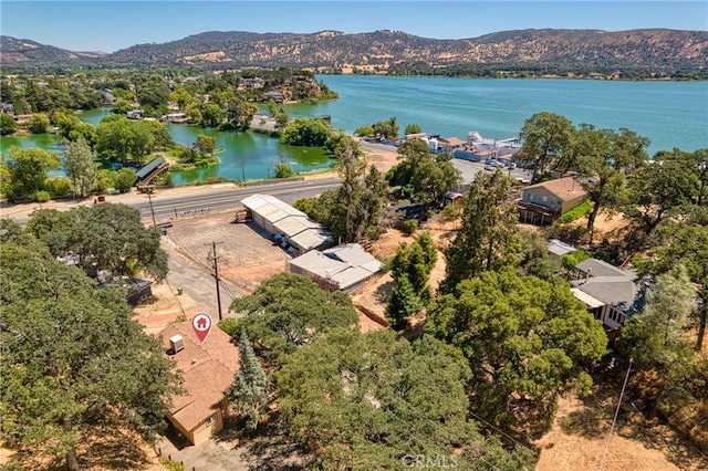 birds eye view of property with a water and mountain view