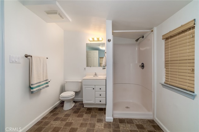 bathroom with walk in shower, vanity, and toilet