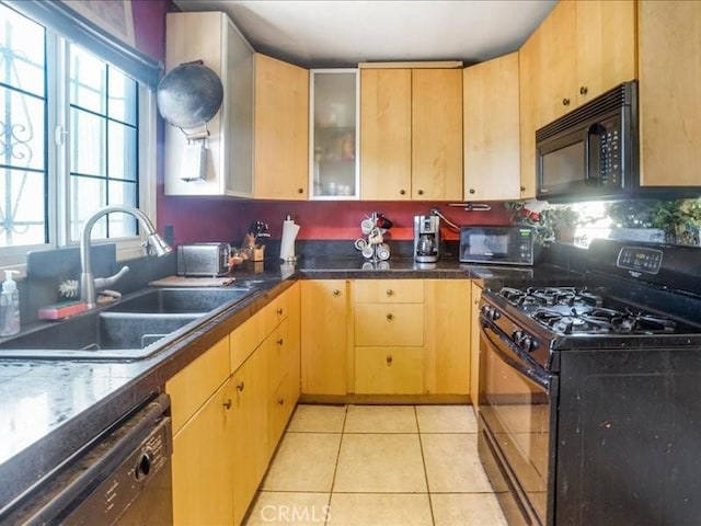 kitchen with light tile patterned floors, sink, light brown cabinets, and black appliances