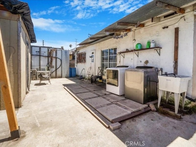 view of patio / terrace with washing machine and clothes dryer