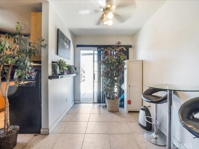 tiled entryway with ceiling fan