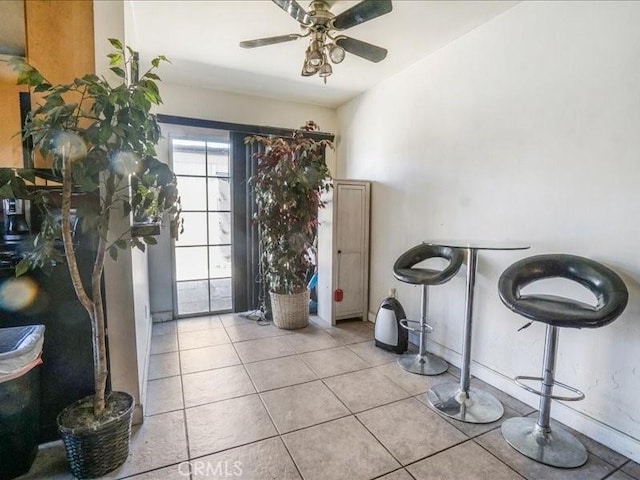 interior space with ceiling fan and light tile patterned floors