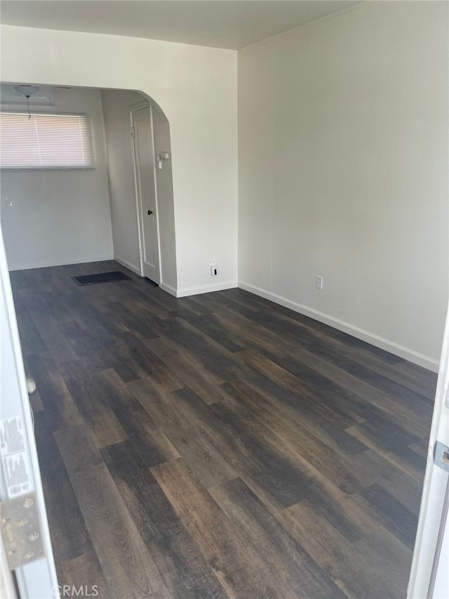 unfurnished room with dark hardwood / wood-style flooring