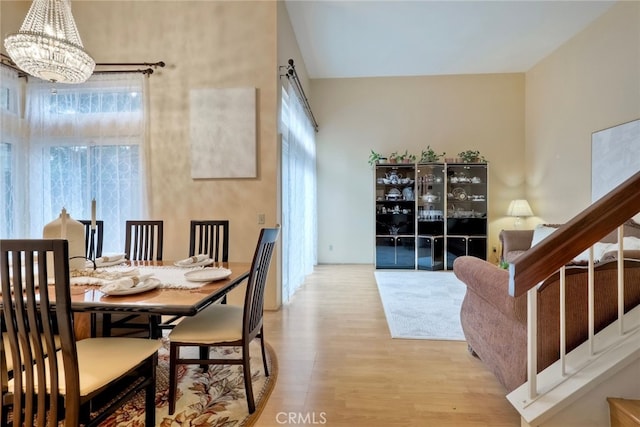 dining room featuring an inviting chandelier and light hardwood / wood-style flooring