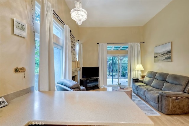 living room with wood-type flooring and an inviting chandelier