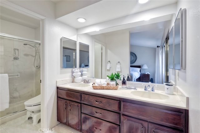 bathroom with vanity, a shower with shower door, toilet, and tile patterned floors