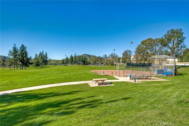 view of property's community featuring a patio, a yard, and an outdoor fire pit