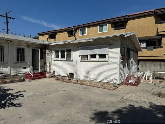 rear view of property featuring a patio