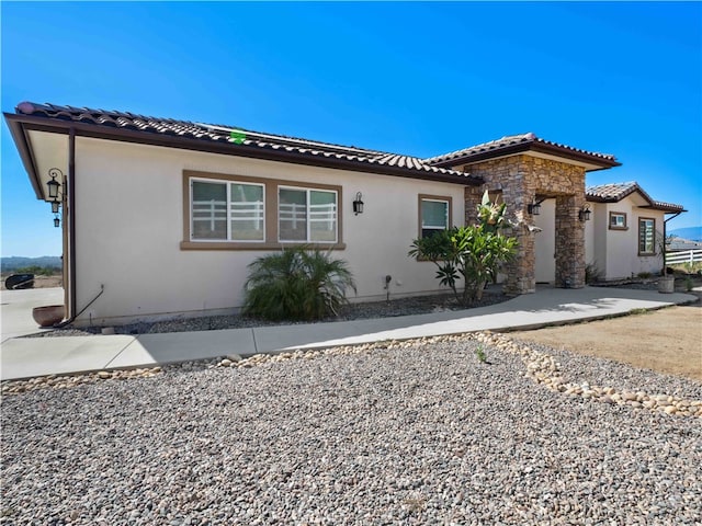 mediterranean / spanish-style home with a patio area