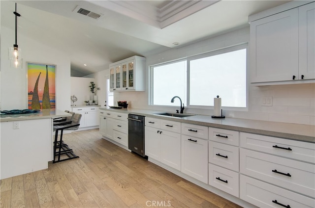 kitchen with light hardwood / wood-style flooring, sink, hanging light fixtures, and white cabinetry