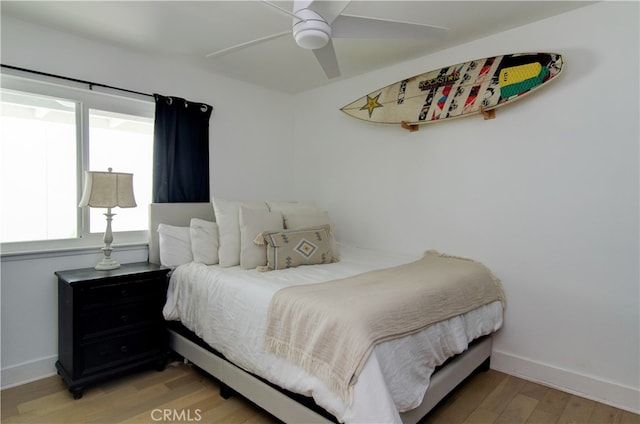 bedroom with light hardwood / wood-style flooring and ceiling fan