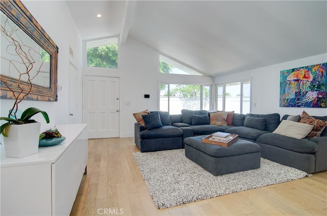 living room with high vaulted ceiling, light wood-type flooring, and beamed ceiling