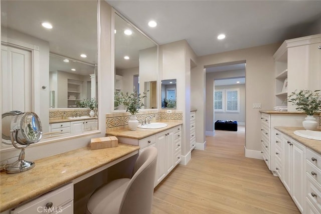 bathroom with vanity and wood-type flooring