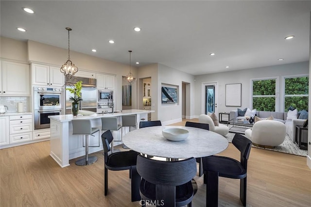 dining area with light hardwood / wood-style floors