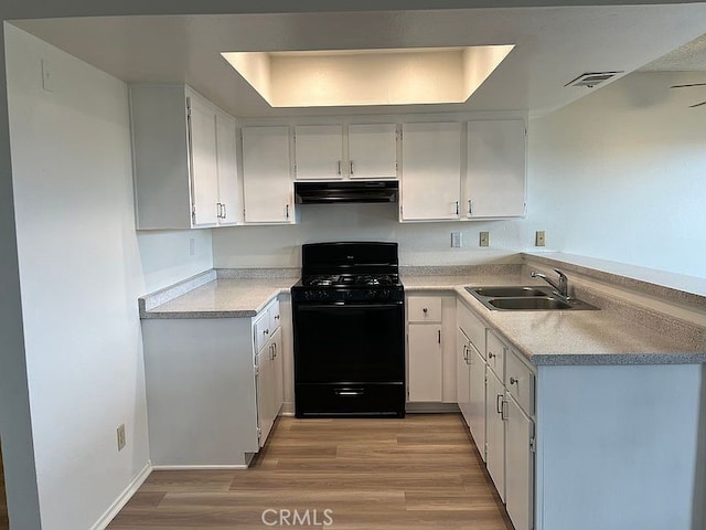 kitchen with light hardwood / wood-style flooring, black gas stove, white cabinets, and sink