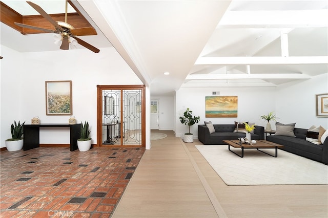 living room with ceiling fan and beamed ceiling