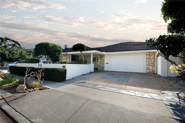 ranch-style home featuring a garage