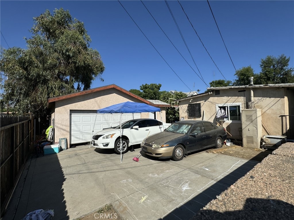 view of vehicle parking featuring a garage