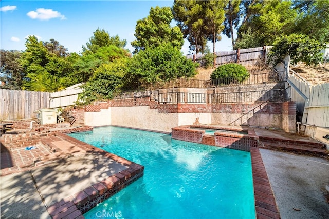 view of swimming pool featuring an in ground hot tub