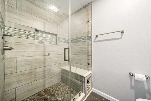 bathroom featuring tile patterned flooring and a shower with door