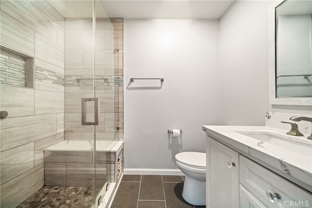 bathroom with walk in shower, vanity, toilet, and tile patterned floors