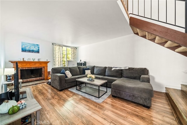 living room featuring a fireplace and light wood-type flooring