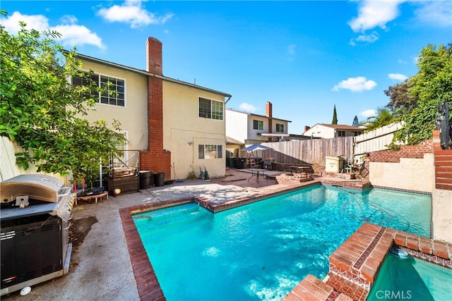 view of swimming pool with a patio area