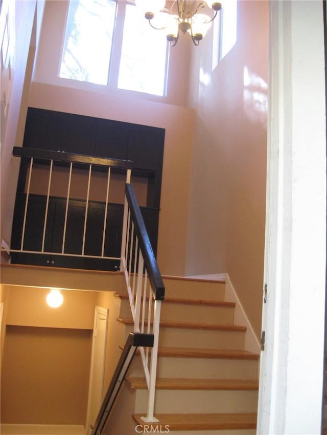 3431 Timber Lk Unit 46, Costa Mesa, CA 92626 - stairway with a healthy amount of sunlight and a chandelier