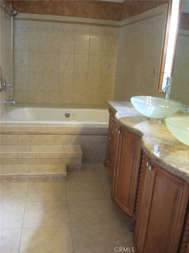 bathroom featuring vanity, tile patterned floors, and tiled shower / bath