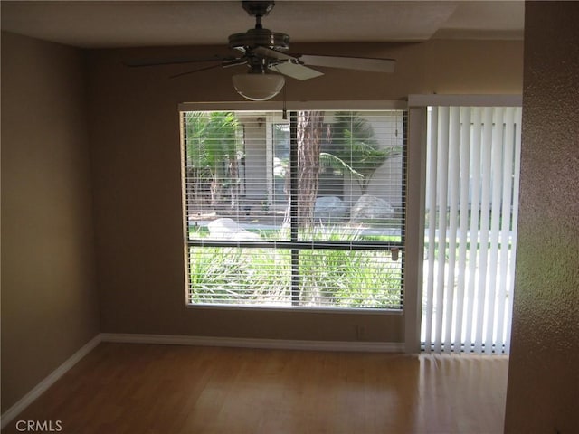 3431 Timber Lk Unit 46, Costa Mesa, CA 92626 - unfurnished dining area with baseboards, a ceiling fan, and wood finished floors